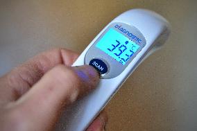 contactless medical digital thermometer, temperature measurement, symptoms, fever