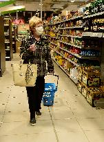 Two hours in food shops, drugstores, pharmacies for seniors only, shop, shopping, senior, protective face mask, woman