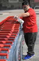 worker disinfects shopping carts against coronavirus, shop, grocery