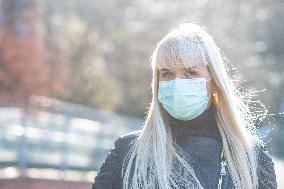 blonde woman with a protection face mask