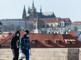 pair of pedestrians with protection face masks on the Charles Bridge in Prague, mask, pedestrian