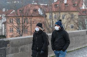 pair of pedestrians with protection face masks on the Charles Bridge in Prague, mask, pedestrian
