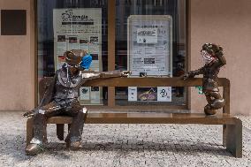 Spejbl (Spaybul) and Hurvinek (Hurveenek) bench, puppets, puppet, protective face mask