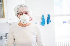 nurse with a respirator in a dental office