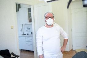 dentist with a respirator in a dental office