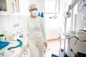 nurse with a respirator in a dental office