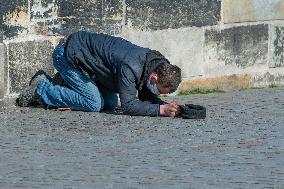 Charles Bridge, beggar, homeless, no tourists, face mask, veil, medical mask