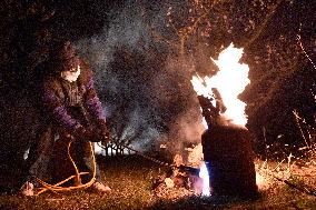 volunteer ignites fire in orchard to protect fruit trees against frost, tree, protection