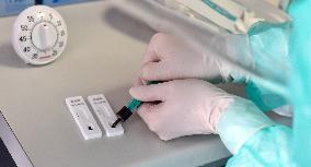 medic performs test for coronavirus with rapid coronavirus tester, blood