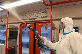 employee disinfects interior of the Prague metro (subway) wagon against coronavirus