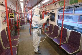 employee disinfects interior of the Prague metro (subway) wagon against coronavirus