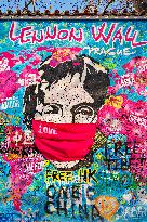 John Lennon portrait with a protection face mask on the Lennon Wall on Kampa Island in Prague