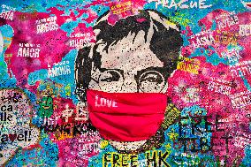 John Lennon portrait with a protection face mask on the Lennon Wall on Kampa Island in Prague