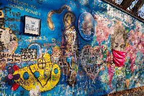 John Lennon portrait with a protection face mask on the Lennon Wall on Kampa Island in Prague