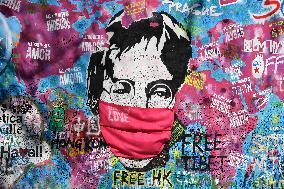 John Lennon portrait with a protection face mask on the Lennon Wall on Kampa Island in Prague