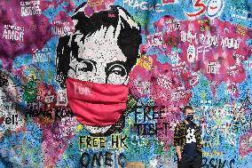 John Lennon portrait with a protection face mask on the Lennon Wall on Kampa Island in Prague