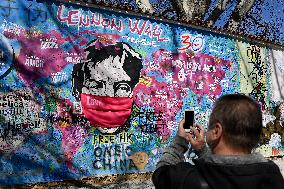 John Lennon portrait with a protection face mask on the Lennon Wall on Kampa Island in Prague