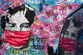 John Lennon portrait with a protection face mask on the Lennon Wall on Kampa Island in Prague