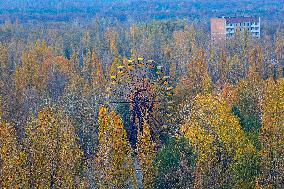 Chernobyl zone, restricted territory, aerial view on deserted town of Pripyat, Ferris wheel