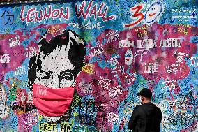 John Lennon portrait with a protection face mask on the Lennon Wall on Kampa Island in Prague