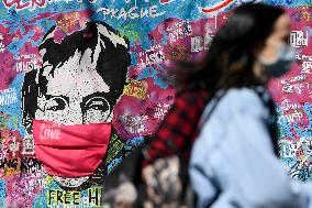 John Lennon portrait with a protection face mask on the Lennon Wall on Kampa Island in Prague