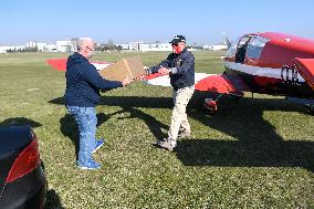 pilot Pavel Kratochvil loads boxes with respirators and masks into an aircraft Zlin Z143 L (Z143L), medical supplies