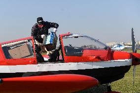 pilot Pavel Kratochvil loads boxes with respirators and masks into an aircraft Zlin Z143 L (Z143L), medical supplies
