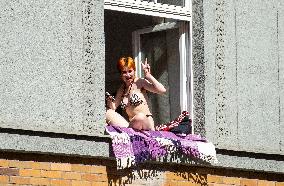 woman sunbathing in a window, bikini swimsuit, gesture, blanket
