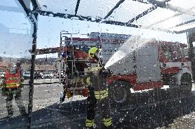 firefighter disinfects a bus stop against coronavirus