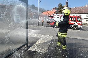 firefighter disinfects a bus stop against coronavirus