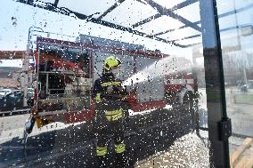 firefighter disinfects a bus stop against coronavirus