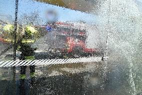 firefighter disinfects a bus stop against coronavirus