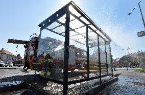 firefighter disinfects a bus stop against coronavirus