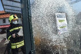 firefighter disinfects a bus stop against coronavirus