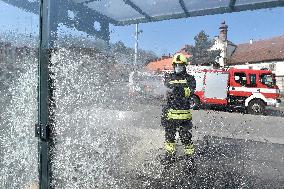 firefighter disinfects a bus stop against coronavirus