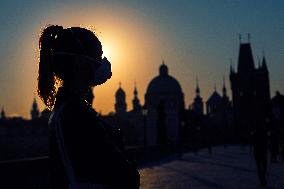 empty Charles Bridge in Prague, girl, face mask, coronavirus