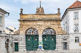 Pilsner Urquell Brewery main gate with a protection face mask