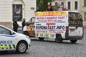 Hradcanske square, delivery van, ad for selling covid-19 tests and a protest against a pig slaughter organised by Mynar