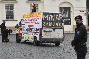 Hradcanske square, delivery van, ad for selling covid-19 tests and a protest against a pig slaughter organised by Mynar