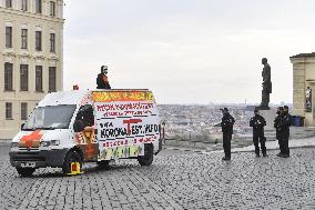 Hradcanske square, delivery van, ad for selling covid-19 tests and a protest against a pig slaughter organised by Mynar