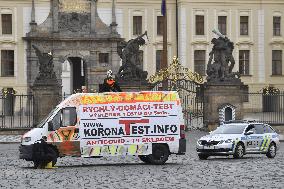 Hradcanske square, delivery van, ad for selling covid-19 tests and a protest against a pig slaughter organised by Mynar