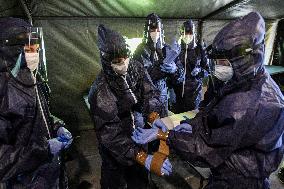 medics prepare to take samples for a covid-19 test from volunteers