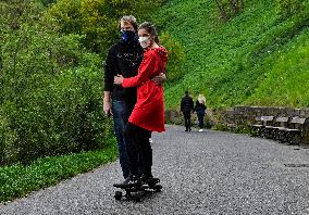 Man, woman, face mask, skateboard, longboard, epidemic, Coronavirus, Prague Castle