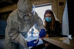 a medic takes a sample for a covid-19 test from a volunteer