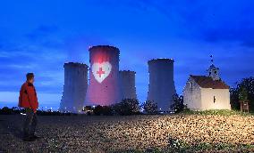 projection of a heart with a cross on a cooling tower of the Dukovany Nuclear Power Station (plant)