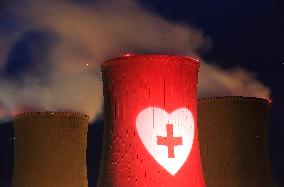 projection of a heart with a cross on a cooling tower of the Dukovany Nuclear Power Station (plant)