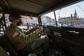 Convoy of U.S. Army World War Two military vehicles, celebrations,