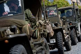 Convoy of U.S. Army World War Two military vehicles, celebrations,