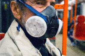 an eldery man with P3R half mask respirator in Prague metro