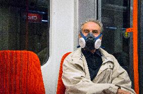 an eldery man with P3R half mask respirator in Prague metro